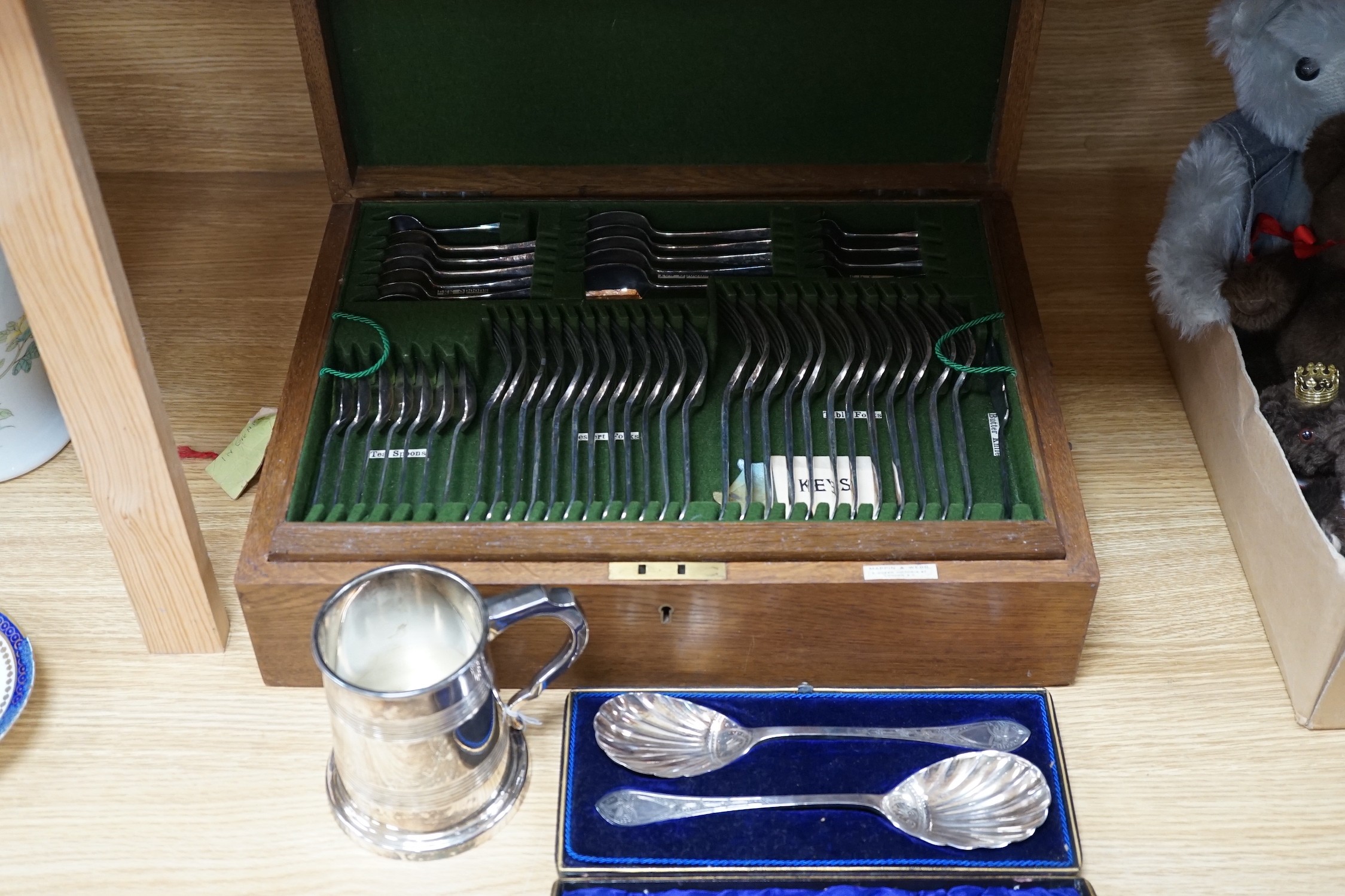 A Mappin & Webb canteen plated cutlery with ivorine inset, cased pair plated servers spoons and plated pint mug